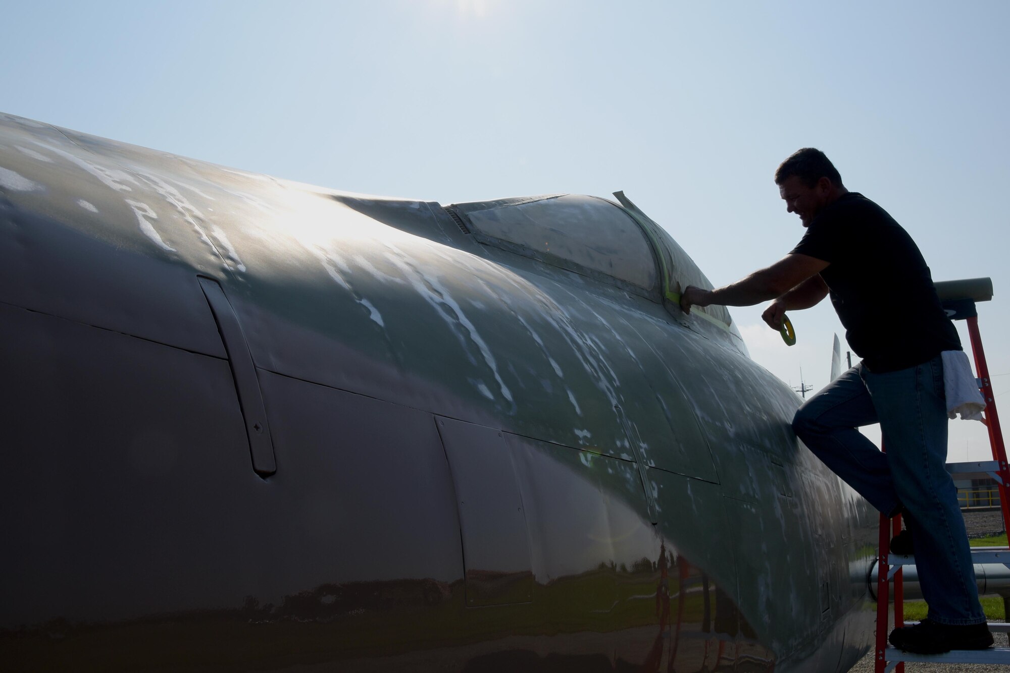 Master Sgt. James Mundy, a member of the 178th Wing, restores aircraft static displays at Springfield Air National Guard Base in Ohio, Aug. 15, 2017. Although the static displays only need fully restored about every 15 years, Mundy conducts annual touch-ups to ensure the aircraft are in excellent condition.(Ohio Air National Guard photo by Senior Airman Rachel Simones)