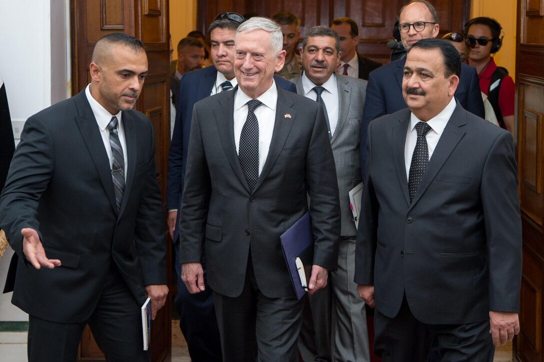 Defense leaders walk together in Baghdad.