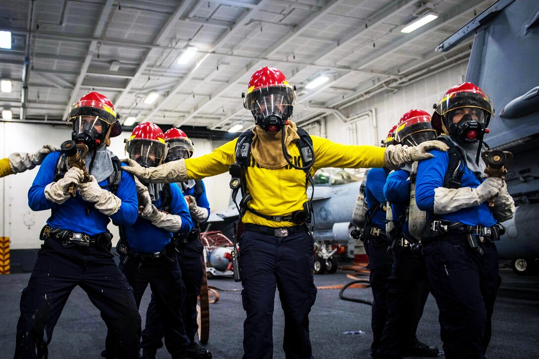 Sailors conduct firefighting exercises.
