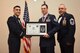 U.S. Air Force Tech. Sgt. David Syring, 316th Training Squadron, receives their certificate of selection from Col. Ricky Mills, 17th Training Wing commander, and Chief Master Sgt. Daniel Stein, 17th Training Group superintendent, during the Senior NCO Induction Ceremony at the Event Center on Goodfellow Air Force Base, Texas, Aug. 18, 2017. (U.S. Air Force photo by Airman 1st Class Chase Sousa/Released)