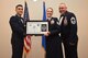U.S. Air Force Tech. Sgt. Erin Weiss, 316th Training Squadron, receives their certificate of selection from Col. Ricky Mills, 17th Training Wing commander, and Chief Master Sgt. Daniel Stein, 17th Training Group superintendent, during the Senior NCO Induction Ceremony at the Event Center on Goodfellow Air Force Base, Texas, Aug. 18, 2017. (U.S. Air Force photo by Airman 1st Class Chase Sousa/Released)