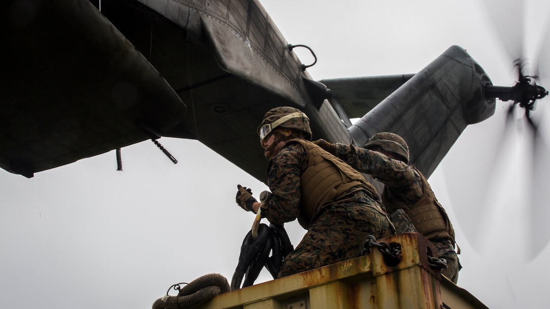 Pfc. Tyler J. Nye (left) and Cpl. Tyler D. Reed (right), both landing support specialist, prepare to attach a container to a CH-53E Super Stallion during external lift training at Draughon Range near Misawa Air Base, Japan, August 21, 2017, in support of exercise Northern Viper 17. This combined-joint exercise is held to enhance regional cooperation between participating nations to collectively deter security threats. Nye, a Lincoln, Nebraska native and Reed, a Waukesha, Wisconsin native, are assigned to Combat Logistics Battalion 4, Combat Logistics Regiment 3, 3rd Marine Logistic Group. (U.S. Marine Corps photo by Lance Cpl. Andy Martinez)