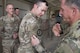 Air Force Chief of Staff Gen. David L. Goldfein, right, places a patch on Maj. Robert Coan, 557th Expeditionary RED HORSE detachment commander, during a during a tour of the 332nd Air Expeditionary Wing, August 21, 2017, in Southwest Asia. While visiting the construction site, Goldfein and Secretary of the Air Force Heather Wilson where briefed about current project to improve the 332nd AEW. (U.S. Air Force photo/Senior Airman Damon Kasberg)