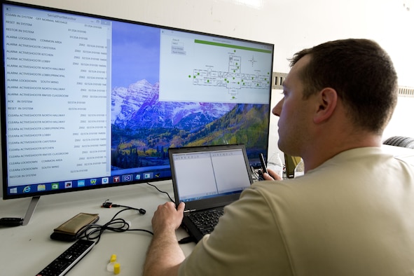 Former U.S. Air Force Capt. Chris Perrine, Air Force Life Cycle Management Center, chief of acquisitions for net centric services-2, from Robbins Air Force Base, Ga., monitors his team’s active shooter detection system during the 2015 Air Force Research Laboratory Commander’s Challenge.