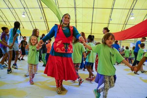 Ellicott school children dance with the Seven Falls Indian Dancers during the Diversity Day closing ceremony at Schriever Air Force Base, Colorado, Friday, Aug. 18, 2017. Diversity Day is Schriever’s opportunity each year to learn about the different cultures while reaching out to the local community. (U.S. Air Force photo/Christopher DeWitt)