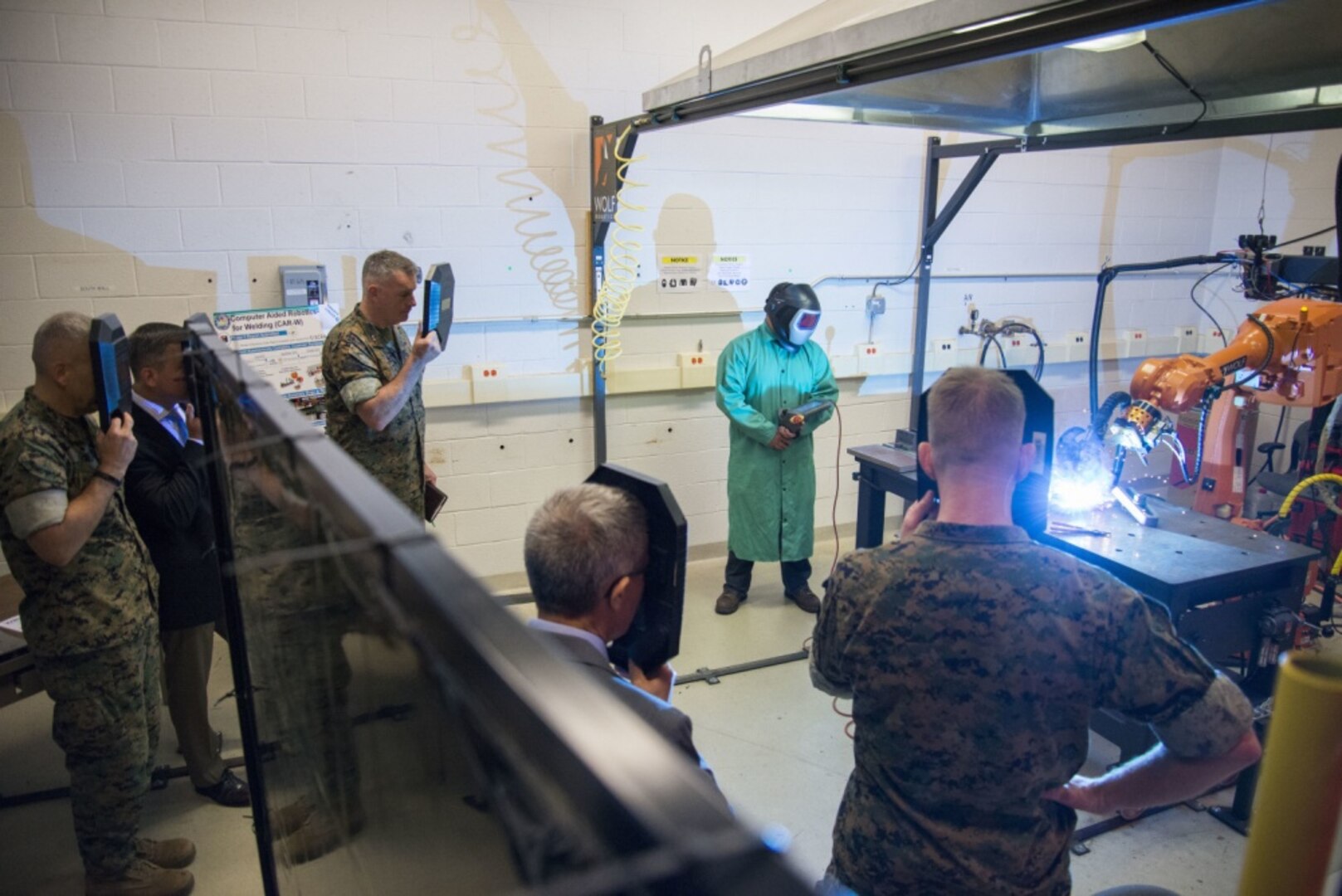 Image: leaders in additive manufacturing watch a welding display