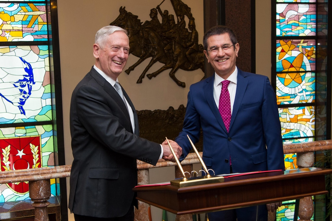 Defense Secretary Jim Mattis shakes hands with Turkey's Defense Minister Nurettin Canikli while in Ankara, Turkey.