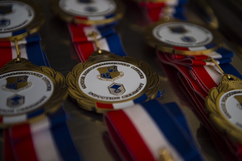 Medallions that will be presented to SNCO inductees are arranged on a tray, 18 August 2017, RAF Alconbury, United Kingdom. (U.S. Air Force photo by Airman 1st Class Zachary Bumpus)
