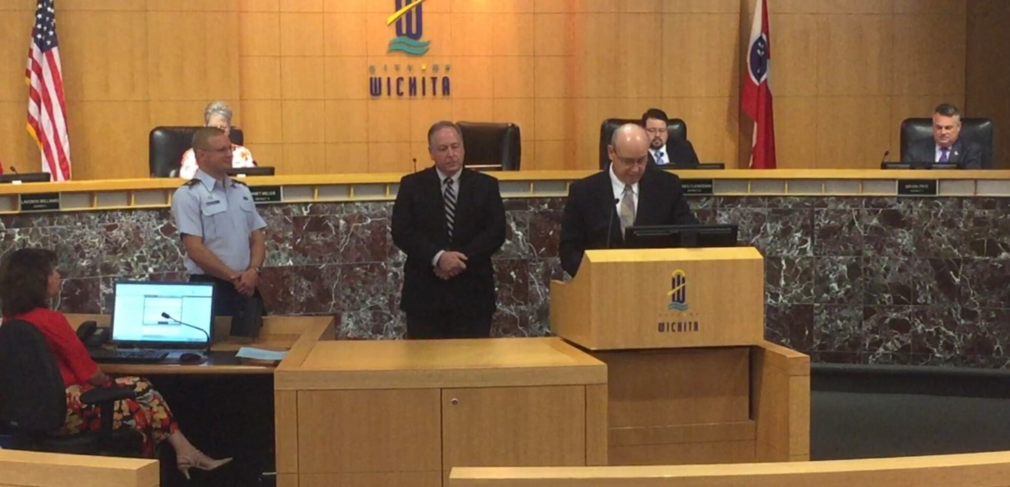 Jeff Longwell (right), City of Wichita mayor, reads a proclamation recognizing Dennis Fry (center), 22nd Contracting Squadron deputy commander, Aug. 15, 2017, during a council meeting in Wichita, Kan. In his time at McConnell Air Force Base, Kan, Fry has overseen more than $78 million spent on firms in the local community. (Courtesy photo)