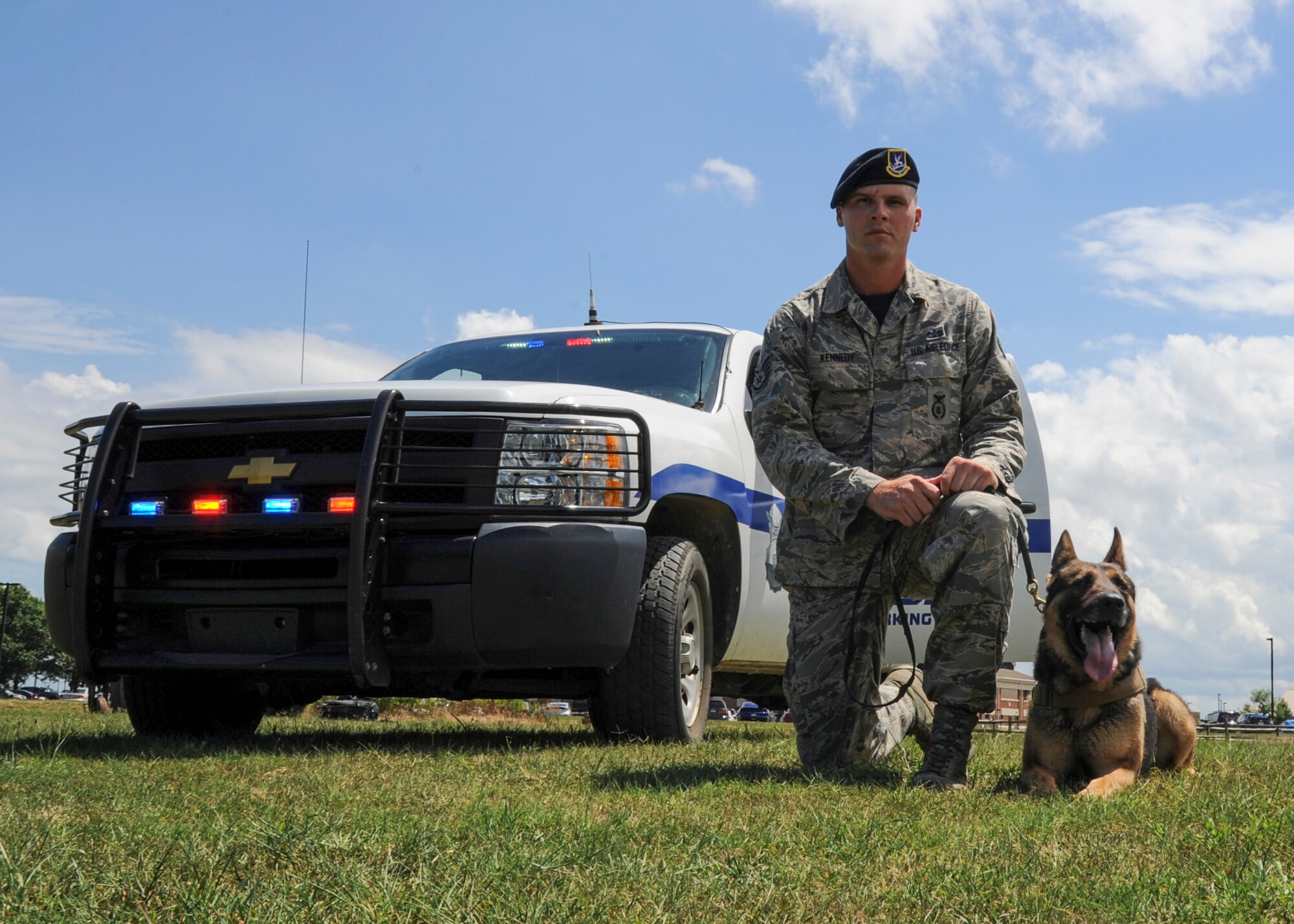 U.S. Air Force Staff Sgt. Jeffrie Kennedy, 633rd Security Forces Squadron military working dog handler, and his partner, Toni, 633rd SFS MWD, pose for a photo at Joint Base Langley-Eustis, Va., Aug. 4, 2017.