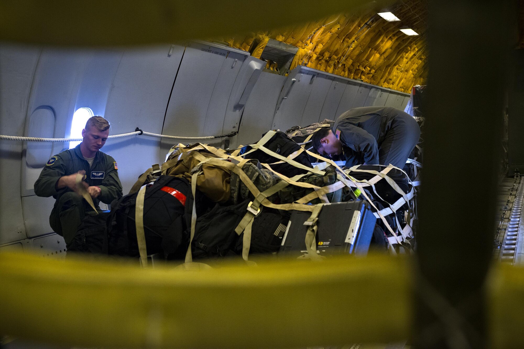 Airmen from the 32d Air Refueling Squadron, Joint Base McGuire-Dix-Lakehurst, N.J., secure cargo for Weapons School, Aug. 19, 2017, at Moody Air Force Base, Ga. The Airmen were travelling to Nellis Air Force Base, Nev., to support the Weapons Instructor Course, which trains tactical experts and leaders to control and exploit air, space and cyberspace. (U.S. Air Force photo by Airman 1st Class Erick Requadt)