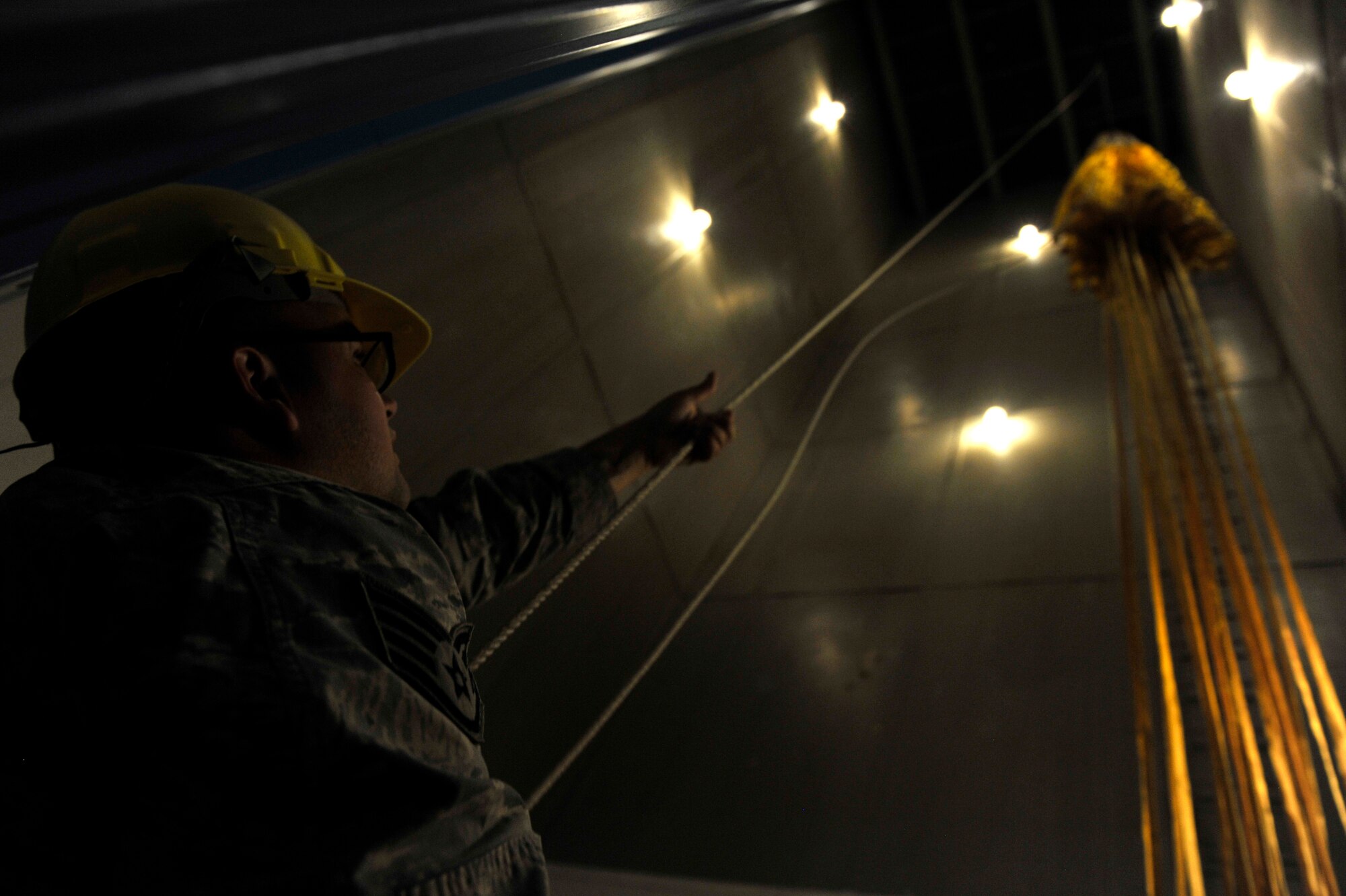 Staff Sgt. Kyle Green, 56th Operation Support Squadron aircrew flight equipment craftsman, hangs a F-16 Fight Falcon drag chute August 18, 2018 at Luke Air Force Base, Ariz. The parachute was hung to clear it of debris and to be inspected. (U.S. Air Force photo/Airman 1st Class Pedro Mota)