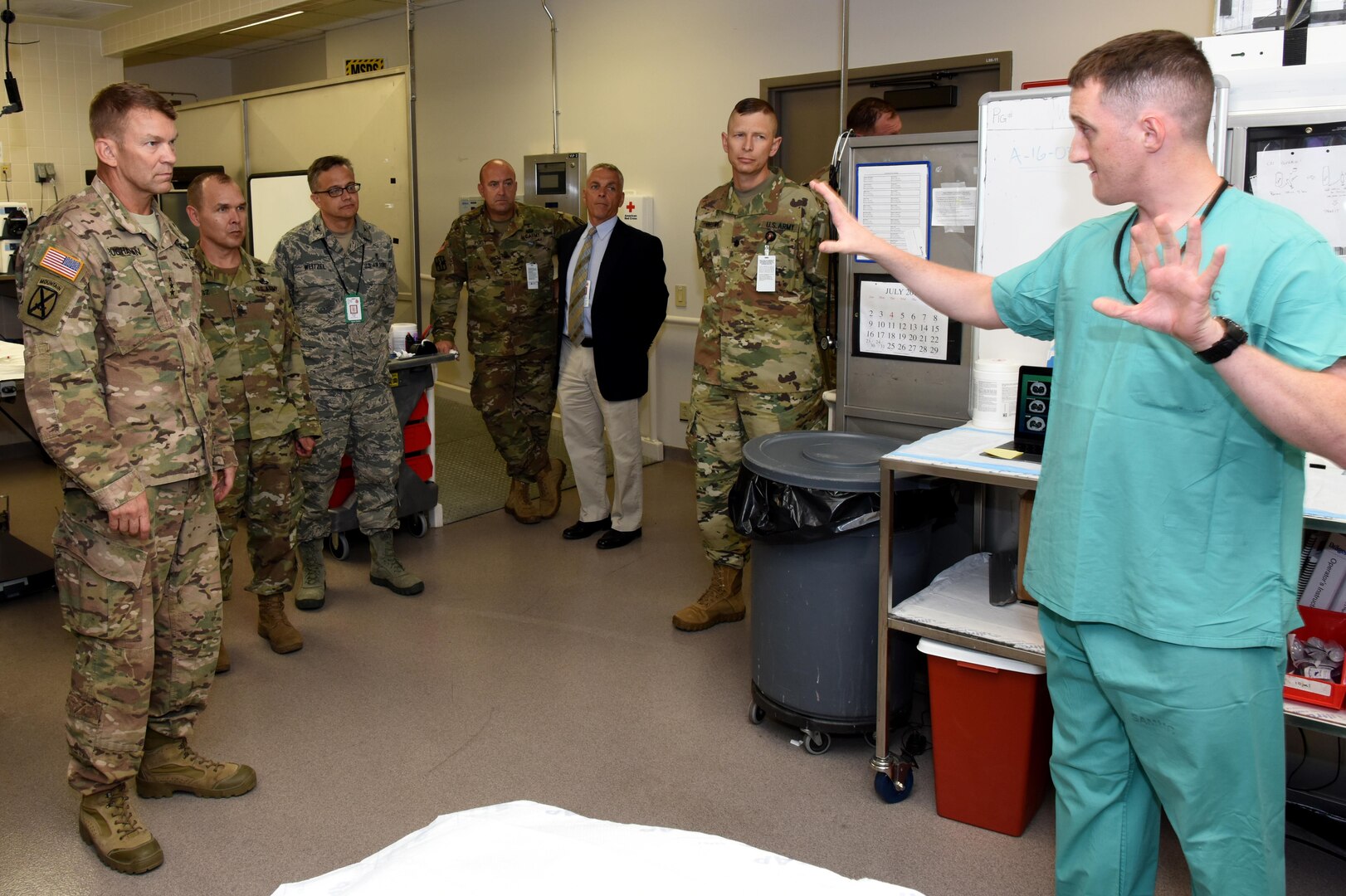 Lt. Gen. Jeffrey Buchanan, U.S. Army North Commanding General, left, gets a brief of the research operating room by Spc. Alexander Dixon during a tour of the U.S. Army Institute of Surgical Research at Fort Sam Houston, Texas as U.S. Army North Command Sgt. Maj. Ronald Orosz, USAISR Deputy Commander, Col. (Dr.) Erik Weitzel, Sgt. Maj. William Poist, Anthony Pusateri, Ph.D., and Lt. Col. (Dr.) Ammon Brown look on.