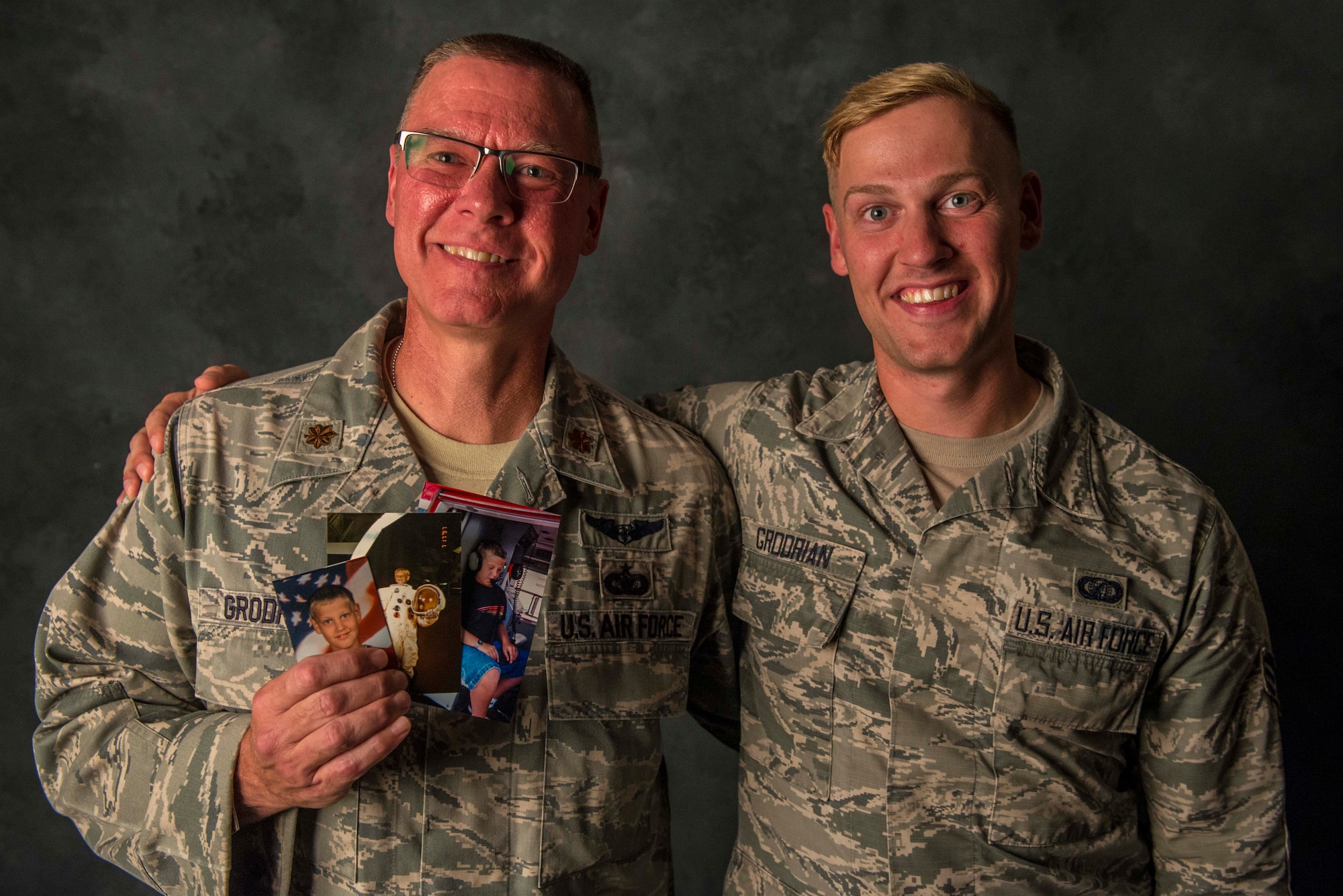 aj. Stanley Grodrian, the flight commander at the Scott Family Health Clinic, and his son, Senior Airman Nathaniel Grodrian, a contracting specialist for the 375th Contracting Squadron, pose for a photo, August 15, 2017, at Scott Air Force Base, Ill.