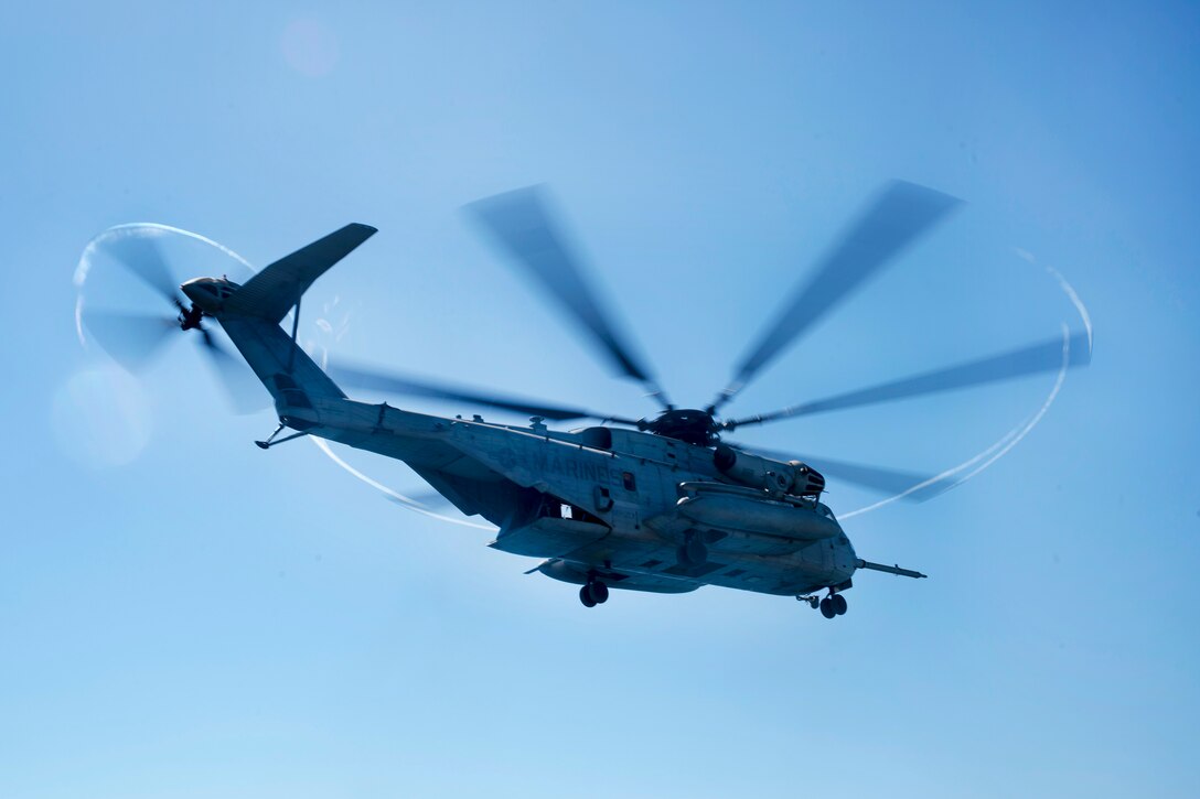 A CH-53E Super Stallion helicopter takes off from the flight deck of the amphibious assault ship USS Bonhomme Richard.