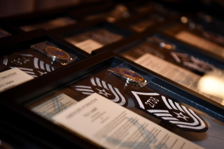 Personalized framed mementos are displayed during the 2017 Senior NCO induction ceremony at Barksdale Air Force Base, La., Aug. 18. The frames included a promotion certificate and personalized coins and master sergeant stripes displaying each inductee's individual line number for promotion.