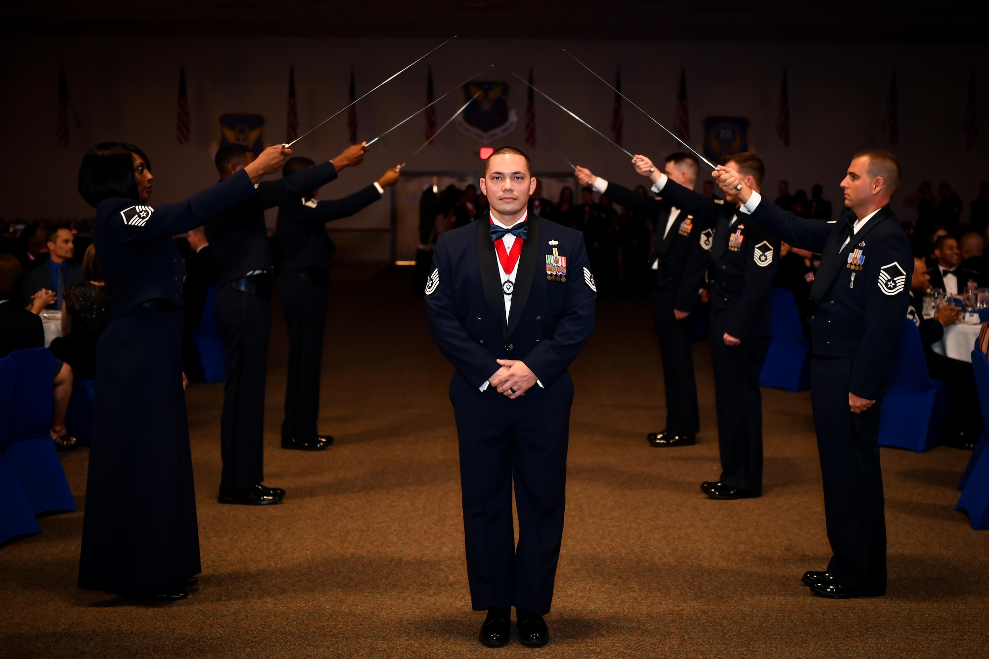 Tech Sgt. Randy Moorhouse, 2nd Logistics and Readiness Squadron Vehicle Operations NCO in charge, poses for a photo after crossing a saber arch during the 2017 Senior NCO induction ceremony at Barksdale Air Force Base, La., Aug. 18. Moorhouse was one of 70 inductees honored during the ceremony, each inductee was introduced as they crossed the saber arch.