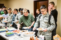 The Scott Air Force Base First Sergeant’s Group prepares a meal for dorm residents. The meals are prepared as part of the Dorm Dinner program, which provides dorm residents a home cooked meal and a chance to interact with different organizations on base.
