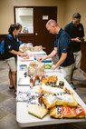 The Scott Air Force Base First Sergeant’s Group prepares a meal for dorm residents. The meals are prepared as part of the Dorm Dinner program, which provides dorm residents a home cooked meal and a chance to interact with different organizations on base.