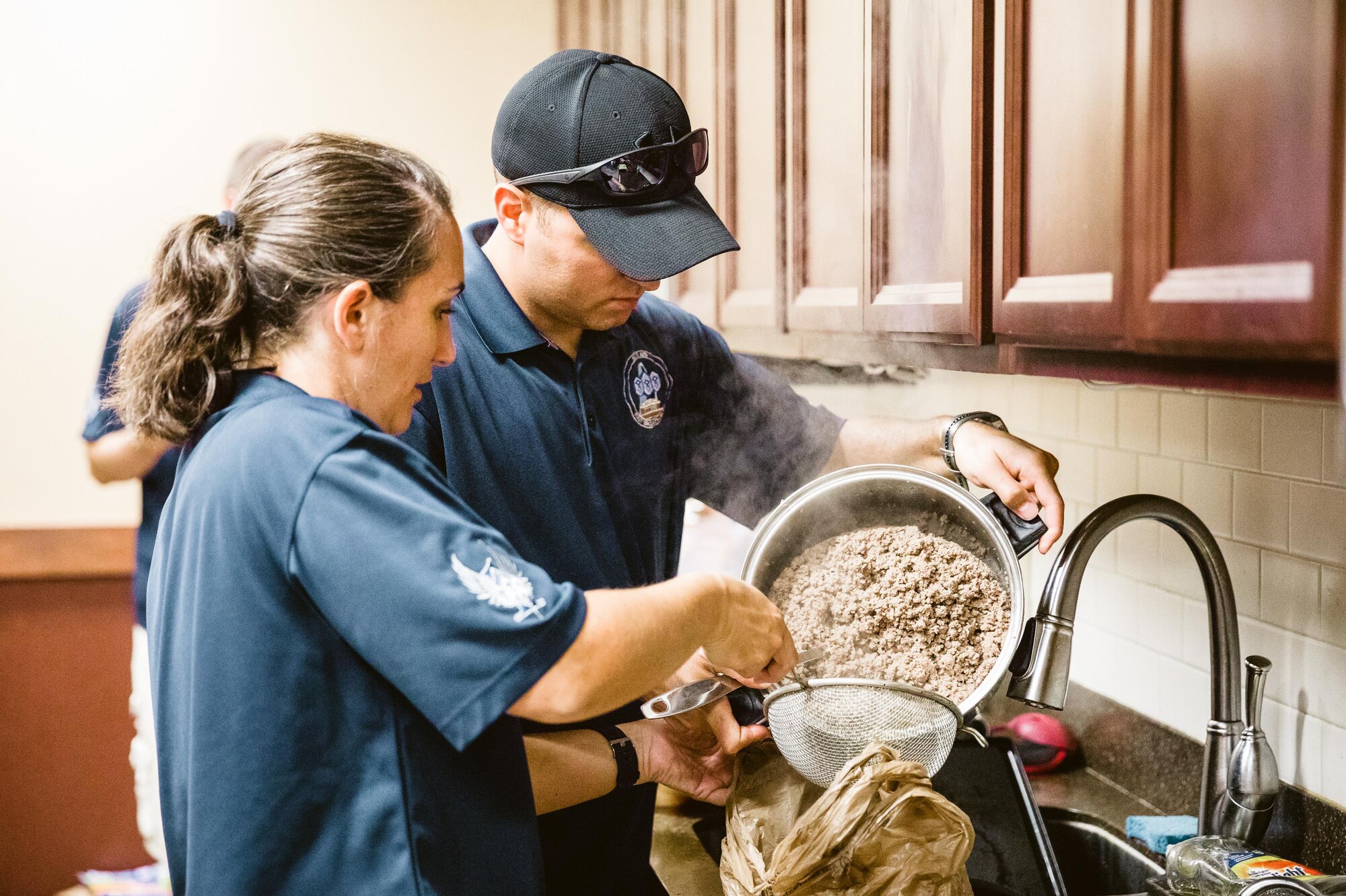 The Scott Air Force Base First Sergeant’s Group prepares a meal for dorm residents. The meals are prepared as part of the Dorm Dinner program, which provides dorm residents a home cooked meal and a chance to interact with different organizations on base.