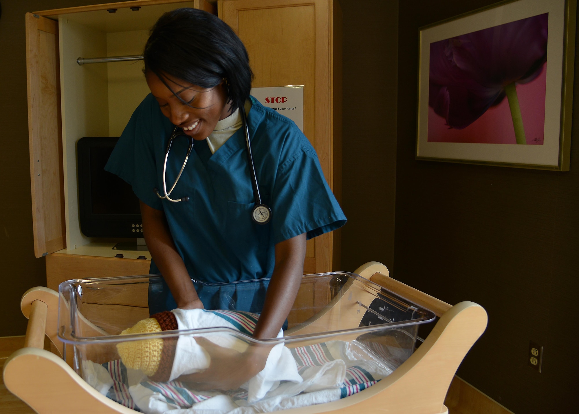 U.S. Air Force Airman First Class Christiana Katta, 633rd Inpatient Squadron medical technician, wraps a newborn baby at Joint Base Langley-Eustis, Va., July 27, 2017.