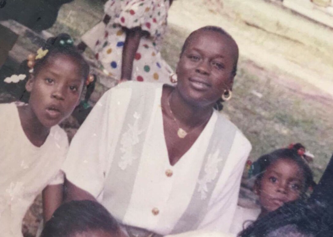 U.S. Air Force Airman 1st Class Christiana Katta (right), 633rd Inpatient Squadron medical technician, poses for a photo with her mother, Deborah Klimeh-Katta (center), in her home country of Liberia.