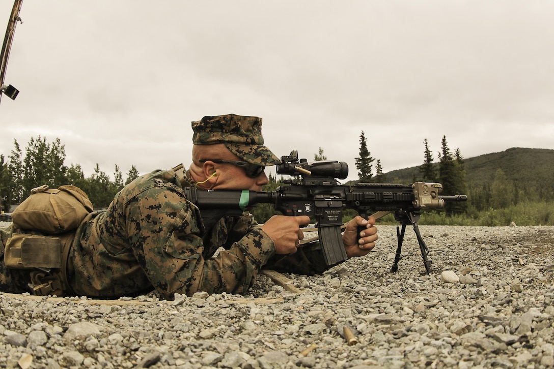 A U.S. Marine participating in the 4th Marine Division Super Squad Competition conducts an Unknown Distance Course of Fire on Grezelka Range, Joint Base Elmendorf-Richardson, Alaska, Aug. 3, 2017.