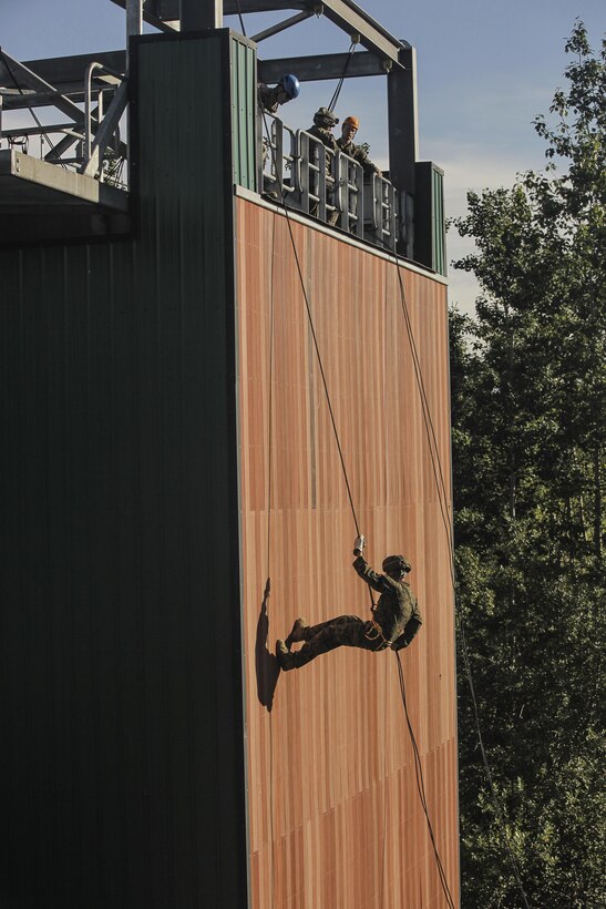 A U.S. Marine participating in the 4th Marine Division Annual Super Squad Competition, Marine Forces Reserve, conducts rappelling practical application during a helo, insertion and mountain rappelling exercise on Camp Carroll, Joint Base Elmendorf-Richardson, Alaska, Aug. 4, 2017.