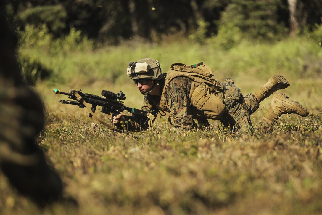 A U.S. Marine with 3rd Battalion, 25th Marine Regiment, 4th Marine Division, Marine Forces Reserve, prepare to move out after being inserted by U.S. Army UH-60 Blackhawks to Landing Zone 15, Joint Base Elmendorf-Richardson, Alaska, Aug. 5, 2017.