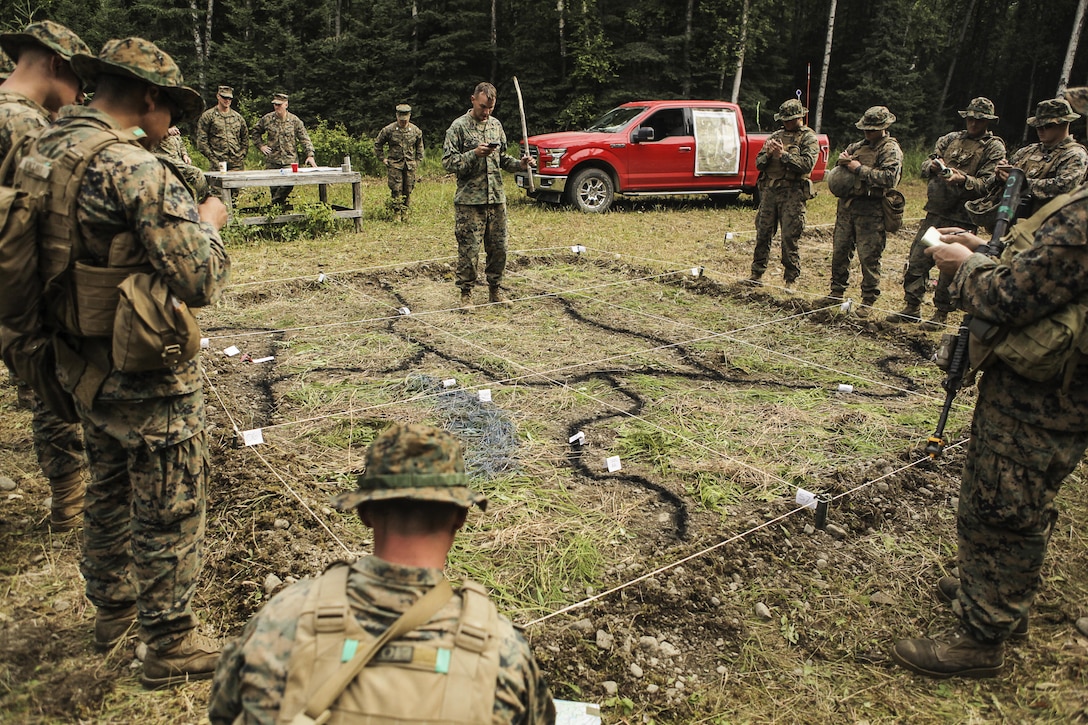U.S. Marines with Super Squad Competition 3rd Squad, out of 3rd Battalion, 25th Marine Regiment, 4th Marine Division, Marine Forces Reserve, take notes during OPORDER brief before conducting a live-fire ambush range on Joint Base Elmendorf-Richardson, Alaska, Aug. 7, 2017.