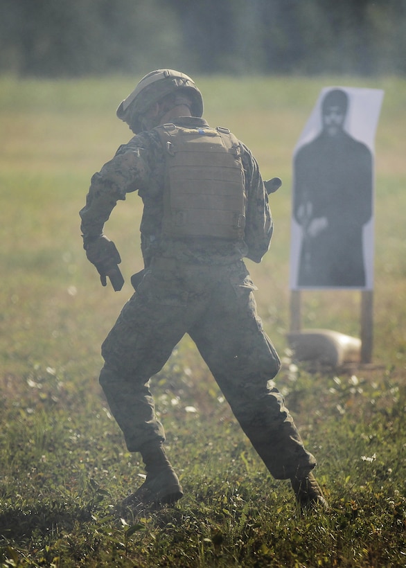 A U.S. Marine with 1st Battalion, 25th Marine Regiment, 4th Marine Division, Marine Forces Reserve and a member of 1st Squad changes magazines on the move while completing a timed live-fire range during the Combat Marksmanship Endurance Test in the Small Arms Complex on Joint Base Elmendorf-Richardson, Alaska, Aug. 8, 2017.