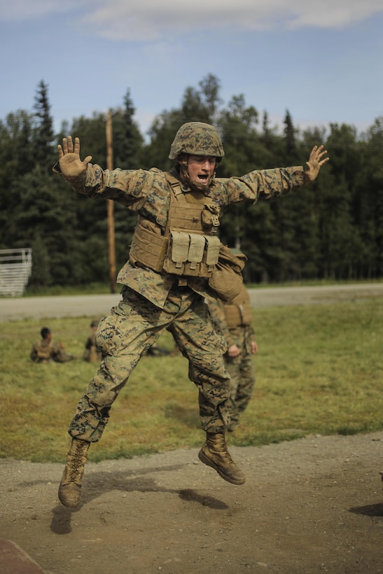 U.S. Marine Corps Sergeant Kelsey with 1st Battalion, 25th Marine Regiment, 4th Marine Division, Marine Forces Reserve and Squad Leader of 2nd Squad conducts 15 burpees before completing a timed live-fire range during the Combat Marksmanship Endurance Test in the Small Arms Complex on Joint Base Elmendorf-Richardson, Alaska, Aug. 8, 2017.