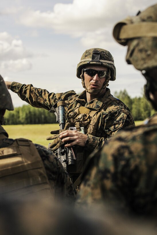 U.S. Marine Corps Sergeant Hahn with 1st Battalion, 25th Marine Regiment, 4th Marine Division, Marine Forces Reserve and Squad Leader of 1st Squad reviews the course of fire and maneuver with the members of his squad before completing a timed grenade assault range during the Combat Marksmanship Endurance Test in the Small Arms Complex on Joint Base Elmendorf-Richardson, Alaska, Aug. 8, 2017.