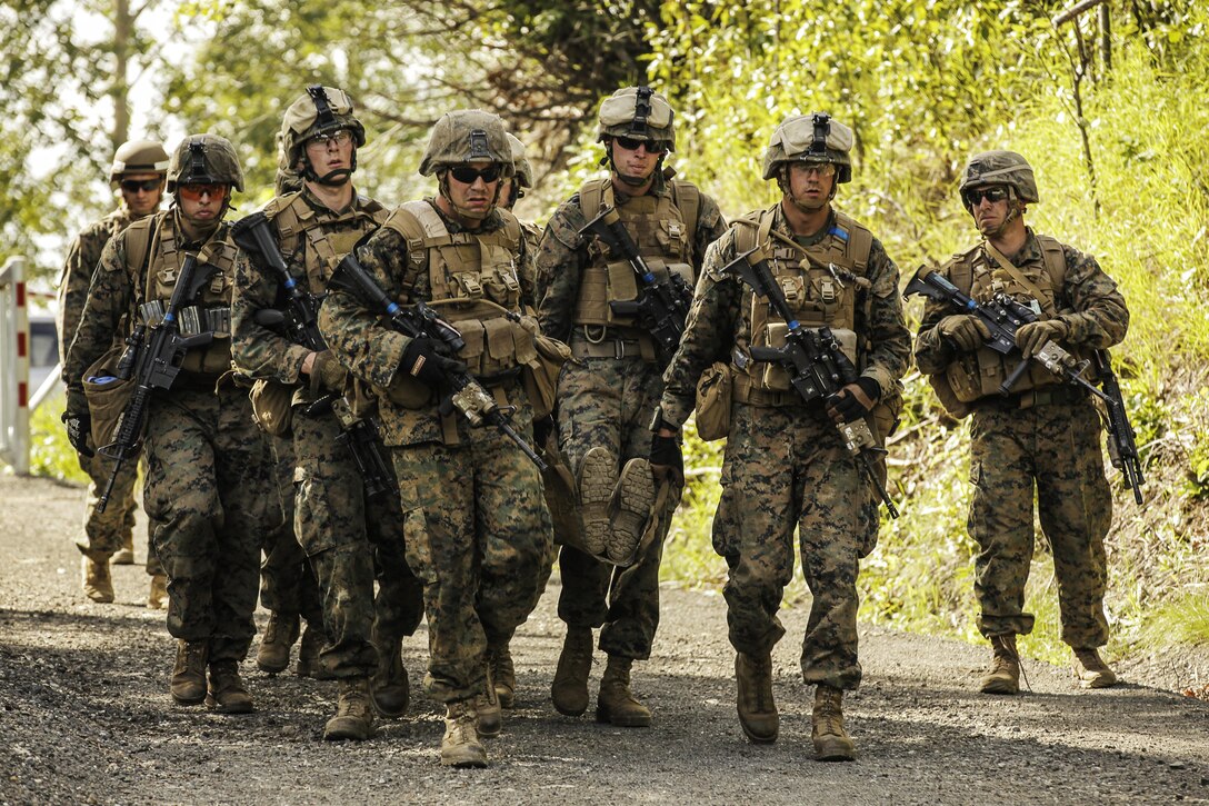 U.S. Marines with Super Squad Competition 1st Squad, out of 1st Battalion, 25th Marine Regiment, 4th Marine Division, Marine Forces Reserve, evacuate their wounded after sustaining simulated casualties while conducting offensive/defensive field operations on Joint Base Elmendorf-Richardson, Alaska, Aug. 8, 2017.