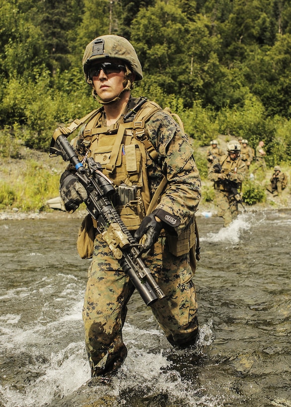 U.S. Marine Corps Corporal Michael May, a Team Leader with Super Squad Competition 1st Squad, out of 1st Battalion, 25th Marine Regiment, 4th Marine Division, Marine Forces Reserve, conducts a river crossing during the Combat Marksmanship Endurance Test Phase II on Joint Base Elmendorf-Richardson, Alaska, Aug. 8, 2017.