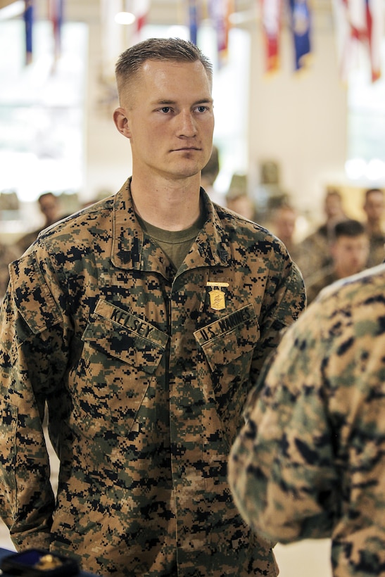 U.S. Marine Corps Sergeant Kelsey with 2nd Battalion, 23rd Marine Regiment, 4th Marine Division, Marine Forces Reserve and Squad Leader of 2nd Squad , stands at attention after recieving the Super Squad Badge during an awards ceremony on Joint Base Elmendorf-Richardson, Alaska, Aug. 9, 2017.