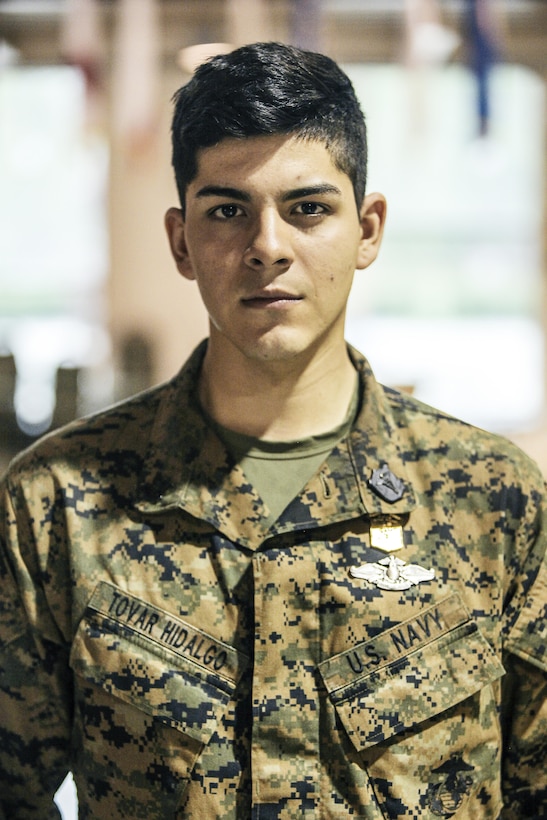 U.S. Navy Corpsman Petty Officer 3rd Class Daniel Tovar with 2nd Battalion, 23rd Marine Regiment, 4th Marine Division, Marine Forces Reserve and Squad Leader of 2nd Squad , stands at attention after recieving the Super Squad Badge during an awards ceremony on Joint Base Elmendorf-Richardson, Alaska, Aug. 9, 2017.
