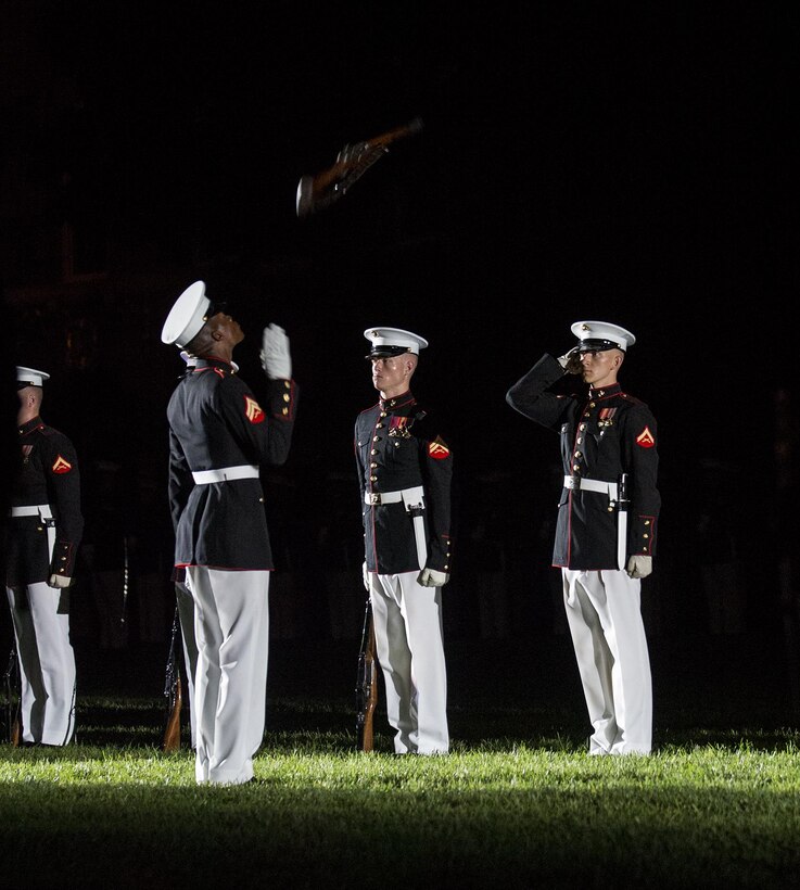 Corporal Jesse M. Thorton, number two rifle inspector, U.S. Marine Corps Silent Drill Platoon, and Lance Cpl. Ryan Watkins, rifle inspection team, SDP, execute a rifle inspection during a Friday Evening Parade at Marine Barracks Washington D.C., Aug. 18, 2017. The guest of honor for the parade was the Superintendent of the U.S. Naval Academy, Vice Adm. Walter E. Carter, Jr., and the hosting official was the Deputy Commandant, Combat Development and Integration Commanding General, Marine Corps Combat Development Command, Lt. Gen. Robert S. Walsh. (Official Marine Corps photo by Lance Cpl. Damon McLean/Released)