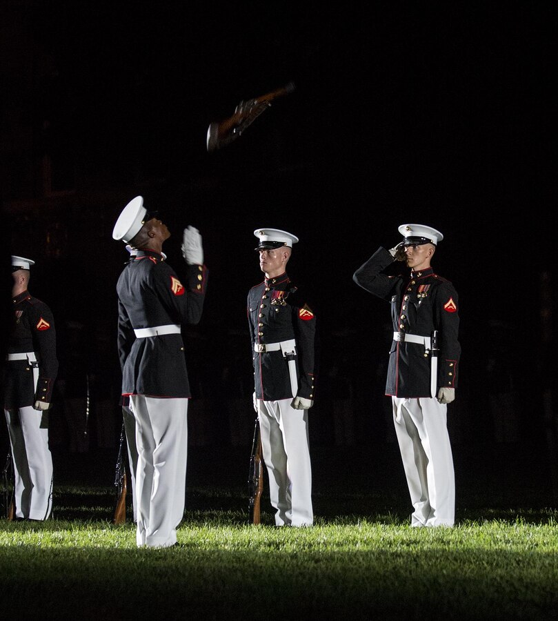 Corporal Jesse M. Thorton, number two rifle inspector, U.S. Marine Corps Silent Drill Platoon, and Lance Cpl. Ryan Watkins, rifle inspection team, SDP, execute a rifle inspection during a Friday Evening Parade at Marine Barracks Washington D.C., Aug. 18, 2017. The guest of honor for the parade was the Superintendent of the U.S. Naval Academy, Vice Adm. Walter E. Carter, Jr., and the hosting official was the Deputy Commandant, Combat Development and Integration Commanding General, Marine Corps Combat Development Command, Lt. Gen. Robert S. Walsh. (Official Marine Corps photo by Lance Cpl. Damon McLean/Released)