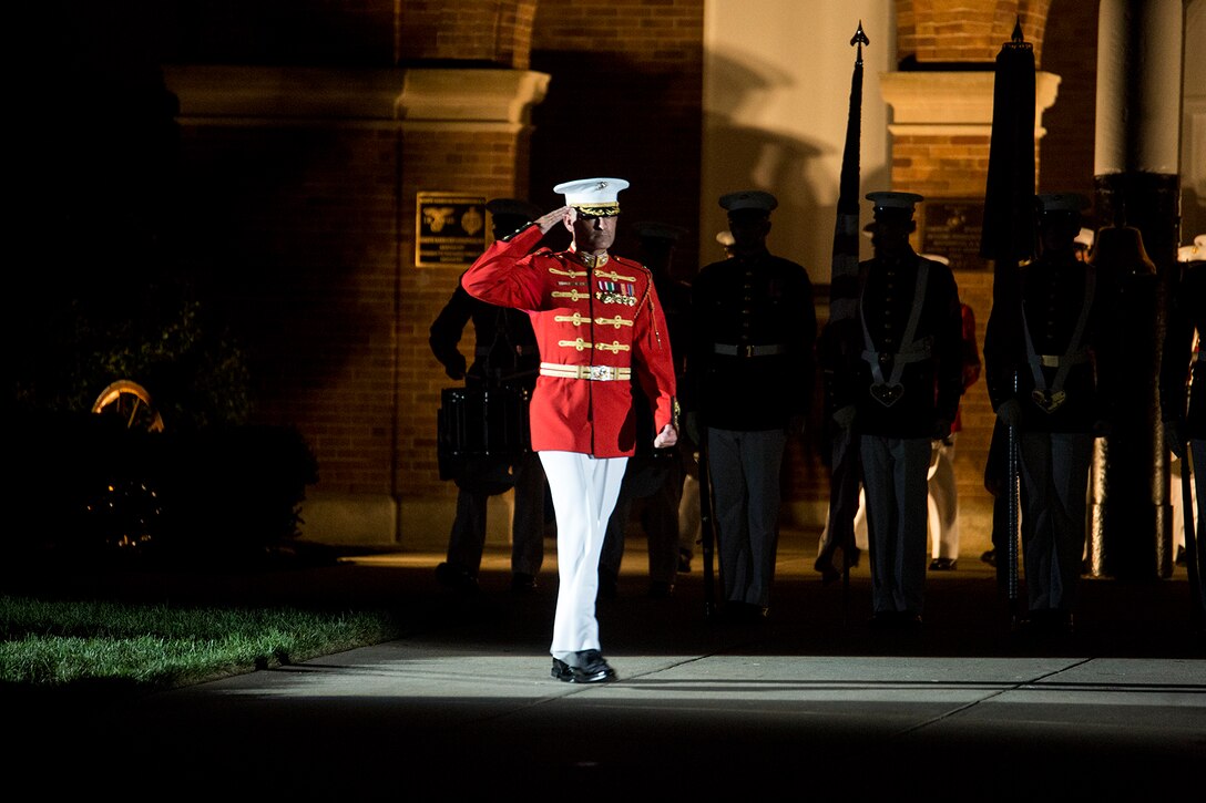 Major Christopher Hall, commanding officer, “The Commandant’s Own” U.S. Marine Drum & Bugle Corps, salutes the National Ensign during a Friday Evening Parade at Marine Barracks Washington D.C., Aug. 18, 2017. The guest of honor for the parade was the Superintendent of the U.S. Naval Academy, Vice Adm. Walter E. Carter, Jr., and the hosting official was the Deputy Commandant, Combat Development and Integration Commanding General, Marine Corps Combat Development Command, Lt. Gen. Robert S. Walsh. (Official Marine Corps photo by Lance Cpl. Damon McLean/Released)