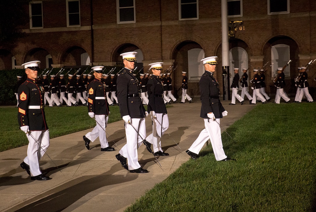 Marines of the parade staff, Marine Barracks Washington D.C., march across the parade deck during a Friday Evening Parade at the Barracks, Aug. 18, 2017. The guest of honor for the parade was the Superintendent of the U.S. Naval Academy, Vice Adm. Walter E. Carter, Jr., and the hosting official was the Deputy Commandant, Combat Development and Integration Commanding General, Marine Corps Combat Development Command, Lt. Gen. Robert S. Walsh. (Official Marine Corps photo by Lance Cpl. Damon McLean/Released)