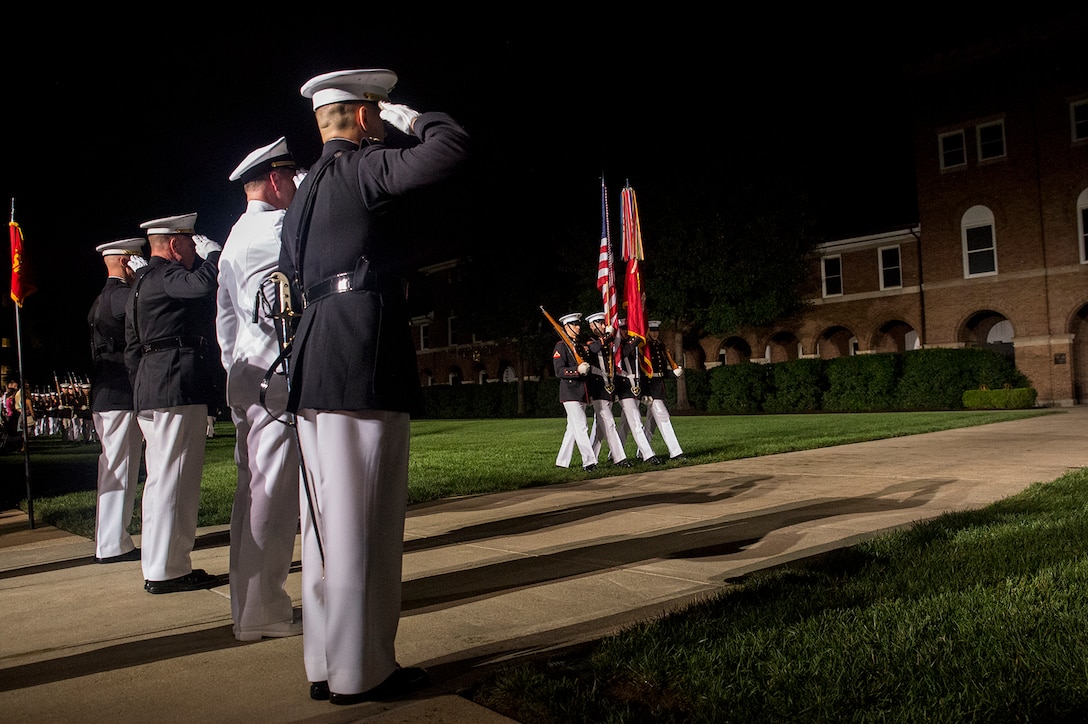 Marines of Marine Barracks Washington D.C., the guest of honor, and hosting official, render honors to the National Ensign at the conclusion of during a Friday Evening Parade at the Barracks, Aug. 18, 2017. The guest of honor for the parade was the Superintendent of the U.S. Naval Academy, Vice Adm. Walter E. Carter, Jr., and the hosting official was the Deputy Commandant, Combat Development and Integration Commanding General, Marine Corps Combat Development Command, Lt. Gen. Robert S. Walsh. (Official Marine Corps photo by Lance Cpl. Damon McLean/Released)