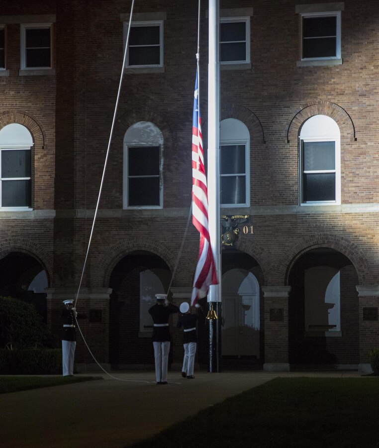 Marines of the color detail, Marine Barracks Washington D.C., conduct evening colors at the conclusion of a Friday Evening Parade at the Barracks, Aug. 18, 2017. The guest of honor for the parade was the Superintendent of the U.S. Naval Academy, Vice Adm. Walter E. Carter, Jr., and the hosting official was the Deputy Commandant, Combat Development and Integration Commanding General, Marine Corps Combat Development Command, Lt. Gen. Robert S. Walsh. (Official Marine Corps photo by Lance Cpl. Damon McLean/Released)