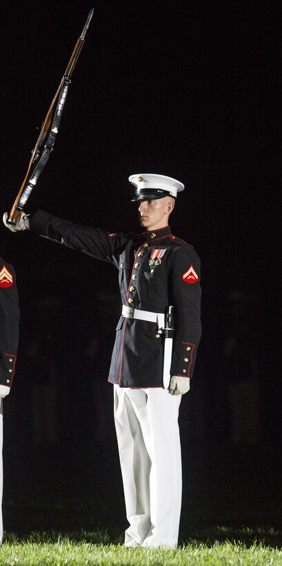 Lance Cpl. Ryan Watkins, rifle inspection team, U.S. Marine Corps Silent Drill Platoon, executes precision rifle drill movements during a Friday Evening Parade at the Barracks, Aug. 18, 2017. The guest of honor for the parade was the Superintendent of the U.S. Naval Academy, Vice Adm. Walter E. Carter, Jr., and the hosting official was the Deputy Commandant, Combat Development and Integration Commanding General, Marine Corps Combat Development Command, Lt. Gen. Robert S. Walsh. (Official Marine Corps photo by Lance Cpl. Damon McLean/Released)