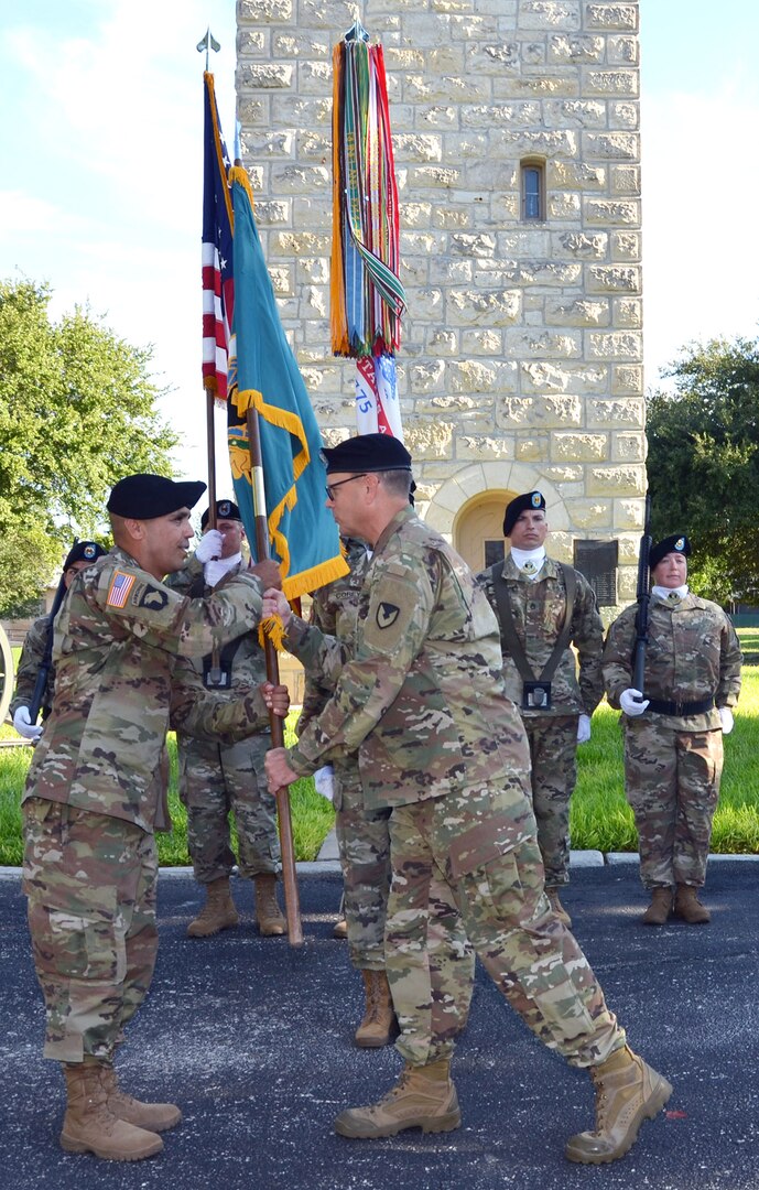 Command Sgt. Maj. Marco A. Torres (left) accepts the Mission and Installation Contracting Command colors from Col. William M. Boruff as color bearer Sgt. 1st Class Quadedra Corey looks on during an assumption-of-responsibility ceremony Aug. 23 at Joint Base San Antonio-Fort Sam Houston, Texas. Boruff is the MICC commander.