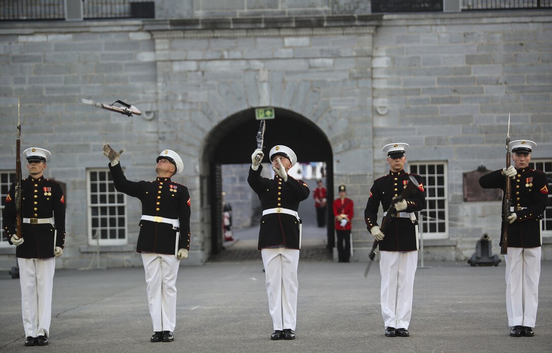 Marines with the U.S. Marine Corps Silent Drill Platoon execute precision drill movements during a combined ceremony at Kingston, Ontario, Canada, Aug. 19, 2017. This visit marked the anniversary of the Ogdensburg Agreement, which was signed by President Roosevelt and Prime Minister King to bind the two nations in the combined defense of North America. Since then, the two units have paraded together countless times both at the Fort and at Marine Barracks Washington. (Official U.S. Marine Corps photo by Lance Cpl. Damon McLean/Released)