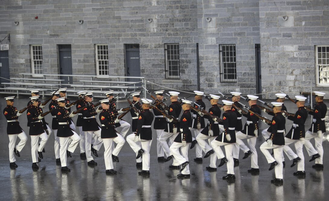 Marines with the U.S. Marine Corps Silent Drill Platoon execute precision drill movements during a combined ceremony at Kingston, Ontario, Canada, Aug. 19, 2017. This visit marked the anniversary of the Ogdensburg Agreement, which was signed by President Roosevelt and Prime Minister King to bind the two nations in the combined defense of North America. Since then, the two units have paraded together countless times both at the Fort and at Marine Barracks Washington. (Official U.S. Marine Corps photo by Lance Cpl. Damon McLean/Released)
