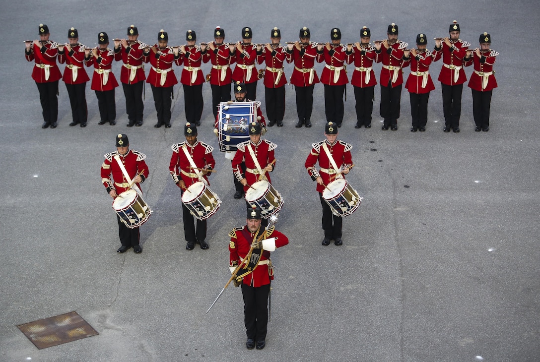 The Fort Henry Guard Drums perform their drum sequence during a combined ceremony at Kingston, Ontario, Canada, Aug. 19, 2017. This visit marked the anniversary of the Ogdensburg Agreement, which was signed by President Roosevelt and Prime Minister King to bind the two nations in the combined defense of North America. Since then, the two units have paraded together countless times both at the Fort and at Marine Barracks Washington. (Official U.S. Marine Corps photo by Lance Cpl. Damon McLean/Released)