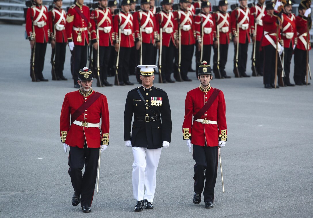 Lieutenant Colonel Scott Clippinger, executive officer, Marine Barracks Washington D.C., is escorted  by Fort Henry Guardsmen during a combined ceremony at Kingston, Ontario, Canada, Aug. 19, 2017. This visit marked the anniversary of the Ogdensburg Agreement, which was signed by President Roosevelt and Prime Minister King to bind the two nations in the combined defense of North America. Since then, the two units have paraded together countless times both at the Fort and at Marine Barracks Washington. (Official U.S. Marine Corps photo by Lance Cpl. Damon McLean/Released)