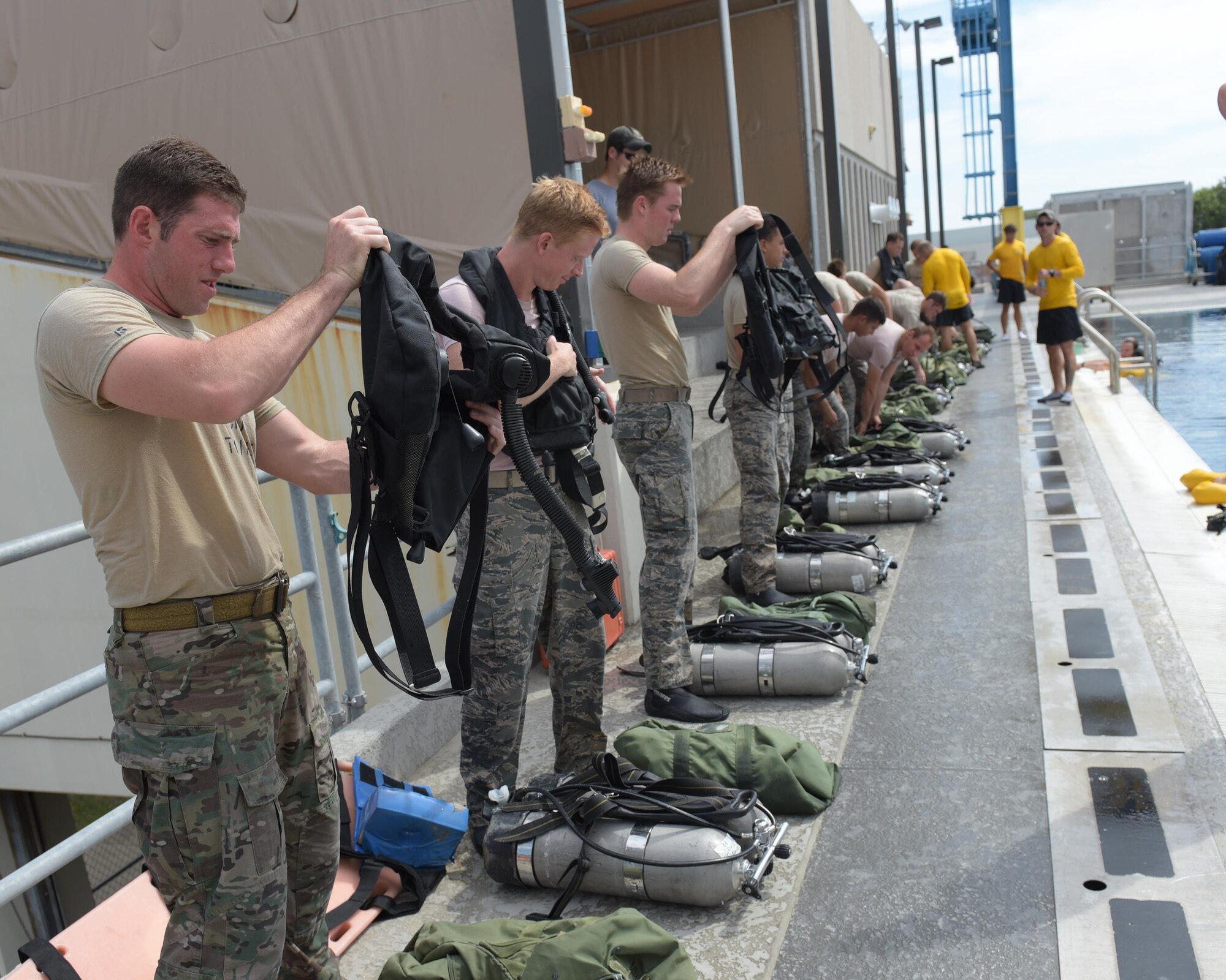 U.S. Air Force dive school students get their equipment ready for a training session at Naval Support Activity Panama City, Fla., Aug. 2, 2017. Both pararescue and combat controller Airmen get their dive training at the Naval Diving and Salvage Training Center.